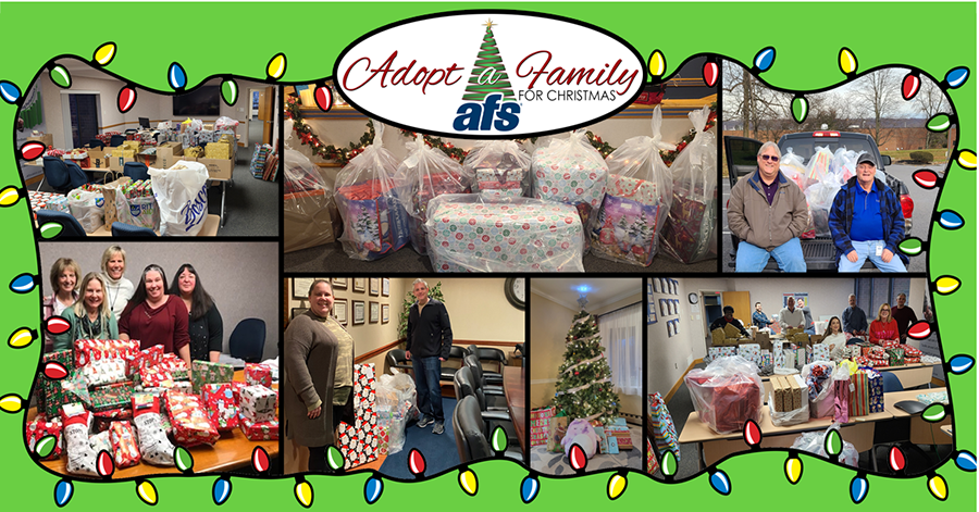 people in front of donated presents for Adopt a Family event